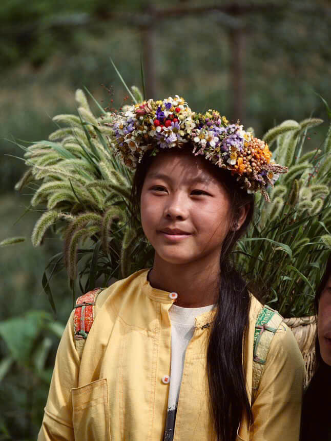 Young Girl Wearing a Vibrant Hand-Woven Flower Crown in Rural Vietnam