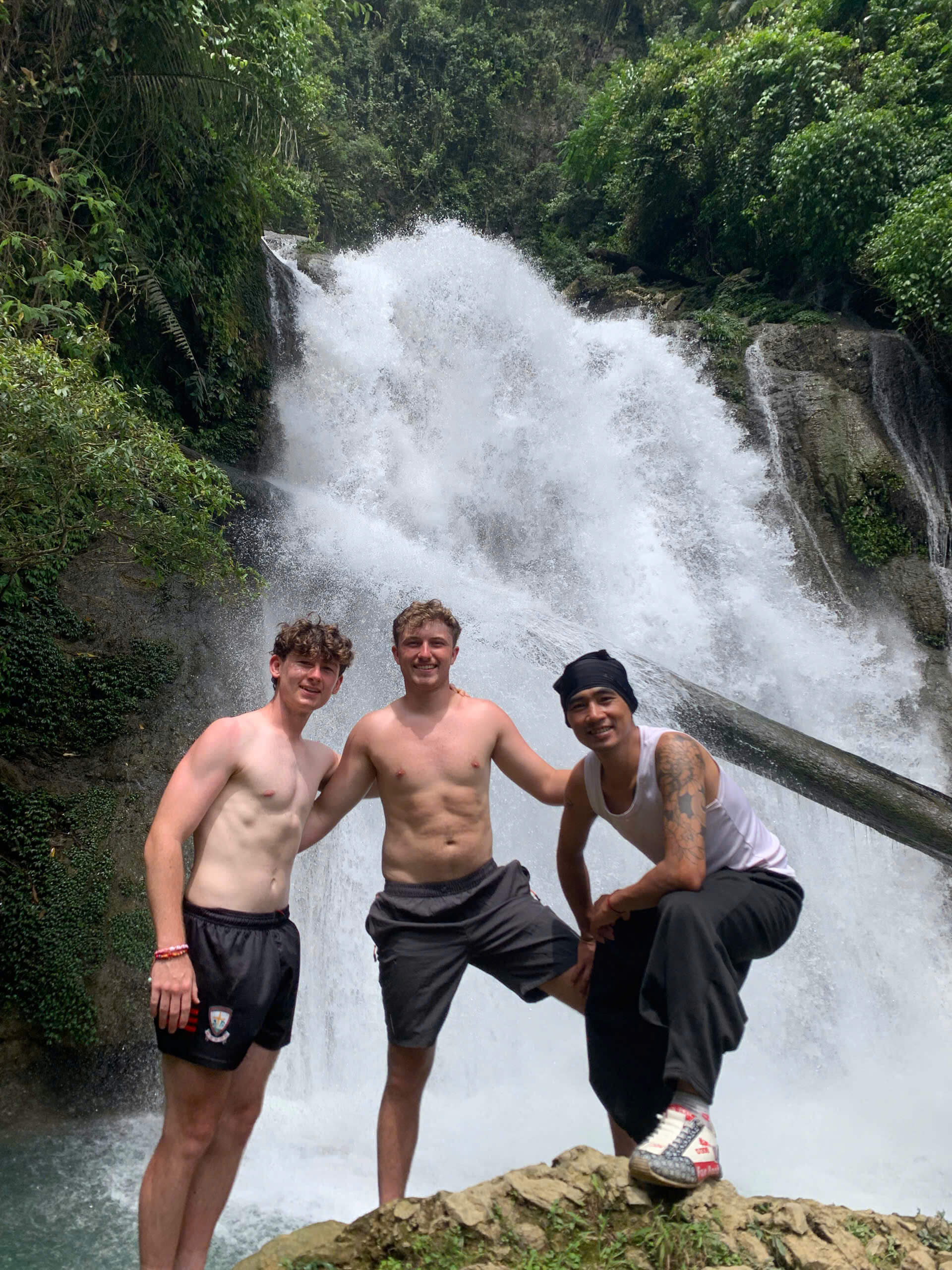 Tourist standing on Khau Lan Waterfall, Ha Giang Loop